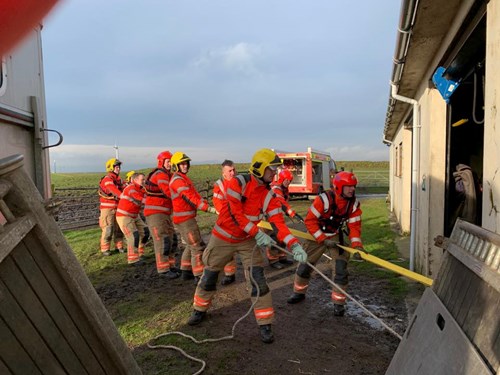 Firefighters use large animal rescue equipment to help Atlas get back on his feet