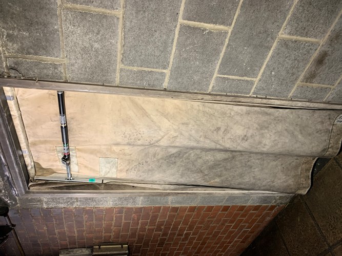 Smoke curtain installed on a brick wall in a building