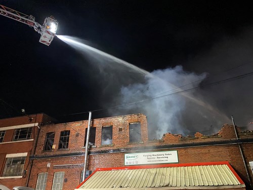 The TTL being used to tackle a fire in Hyde, firefighters in appliance spraying water into building from above
