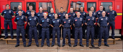 Recruits stood in front of two fire engines