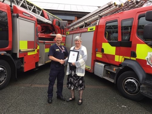 GMFRS volunteer receives certificate from Station Manager Wilson