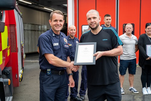 CFO Dave Russel presents Jamie Jackson with commendation (Jamie is holding framed certificate)