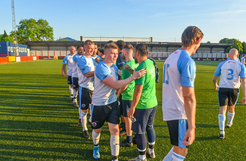 The teams meeting on the pitch