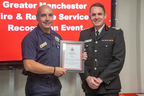 FF Mark Gillard receiving his award from CFO Dave Russel