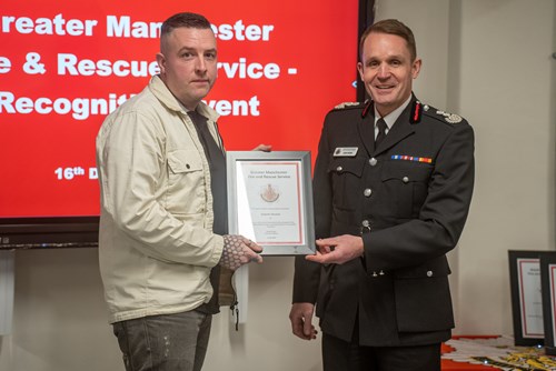 Graeme Burton receiving his award from CFO Dave Russel