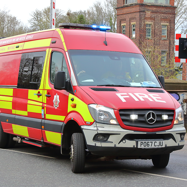 Enhanced Response Unit vehicle driving down a road with buildings in background