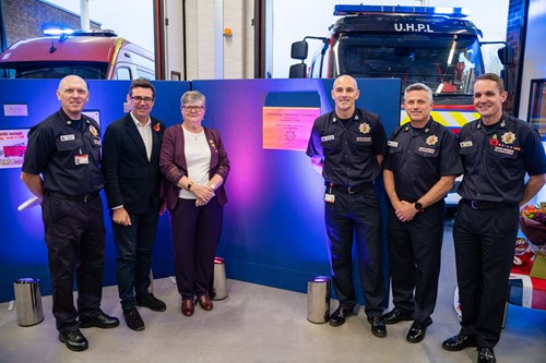 Andy Burnham, Dave Russel and Janet Emsley stood with three firefighters in front of display boards and fire engines