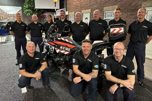 Group photograph of Motorcycle Risk Reduction Team around a fire bike